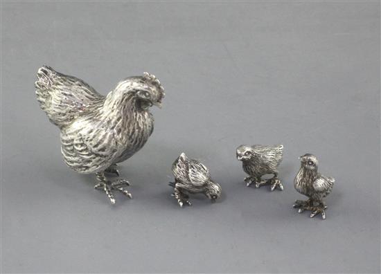 An Italian 800 standard white metal hen and three chicks.